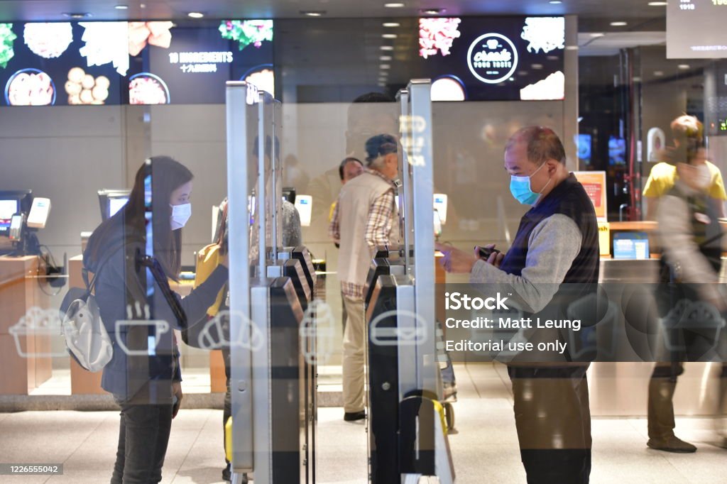 City life in Hong Kong amid pandemic March 25, 2020, Hong Kong: People with face masks are seen ordering food at self-ordering kiosks in a restaurant in Admiralty, Hong Kong, amid the Coronavirus outbreak. Hong Kong Stock Photo