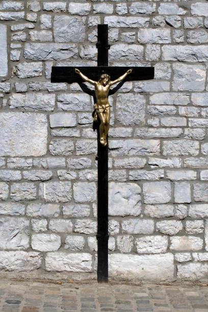 Crucifix in front of a wall stock photo