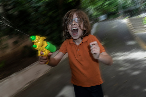 Boy playing with squirt gun