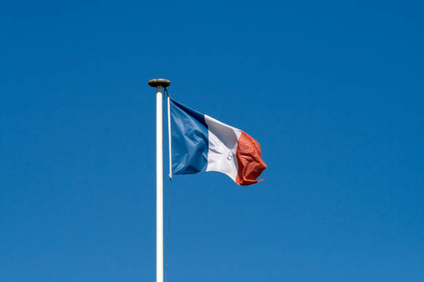 Flag of France floating at the top of a mast stock photo