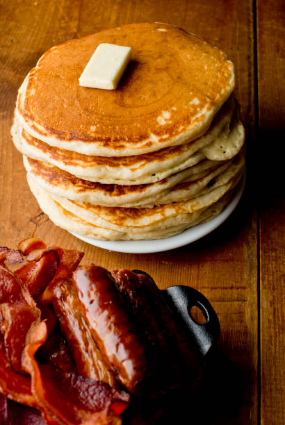 istock Buttermilk pancakes with butter and maple syrup crispy southern fried chicken. Classic American breakfast or brunch favorite. Homemade pancakes served with butter and maple syrup. 1226559805