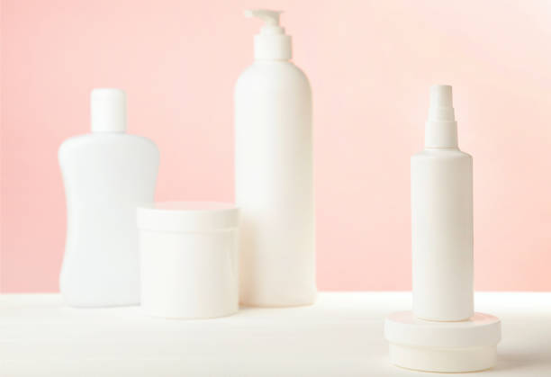 istock White cosmetic bottles on pink background. Top view 1226560829