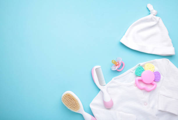 istock Baby clothes with a shower accessories on a blue background 1226561631