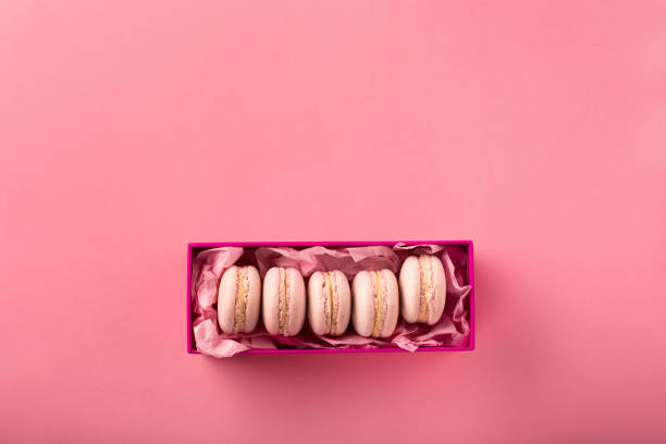 istock Sweet rose macarons on pink background with copy space. 1226562079
