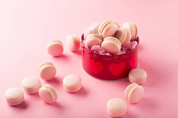 istock Sweet macarons present on pink background with copy space 1226562153
