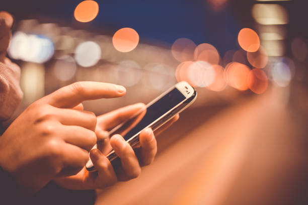 istock Young woman calling on a mobile at train station during early morning (shallow DOF, color toned image) 1226562984