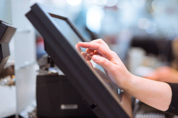 istock Young woman hand doing process payment on a touchscreen cash register, finance concept (color toned image) 1226564190