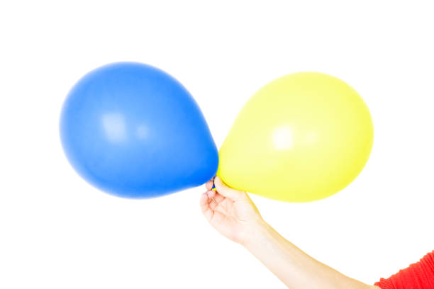 istock Hand holding balloons isolated on white 1226564358