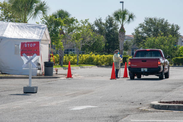 Covid drive up testing Covid 19 drive up testing site in central Florida. Nurse is wearing PPE and is maintaining social distancing from the driver. Signs indicate this is a testing site and are directing drivers to wait until called at a safe distance. A temporary tent shelter for health care staff is visible.
Melbourne, Florida, USA
5/21/2020 robertmichaud stock pictures, royalty-free photos & images