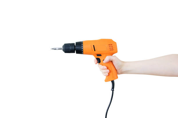 istock Electric orange drill in a caucasian woman hand. White isolate. 1226569659