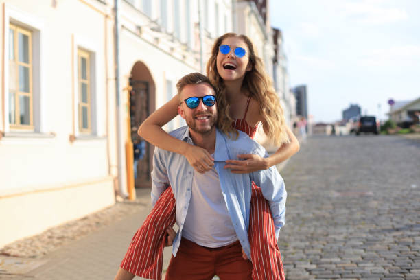 istock Handsome young man carrying young attractive woman on shoulders while spending time together outdoors 1226570390
