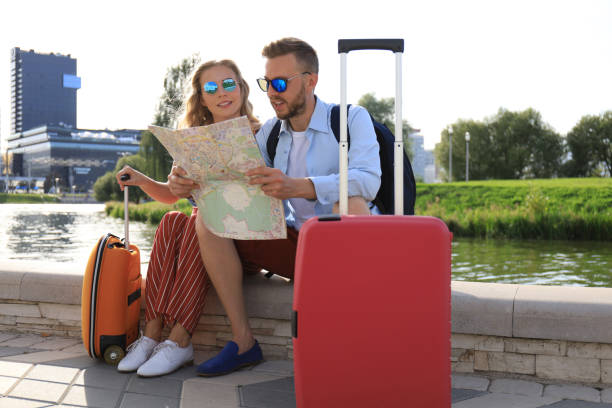 istock Lovely couple on vacation are looking at map for direction 1226570497