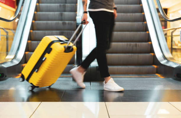 istock Man walking with suitcase at airport terminal 1226573104