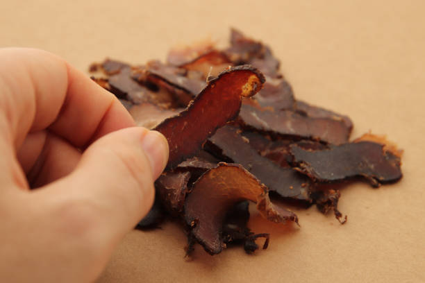 istock Biltong (beef jerky) on a wooden board. 1226576186