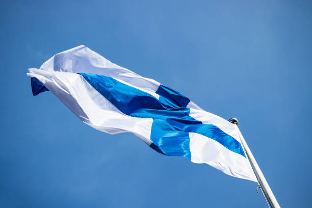 istock Finnish national flag on the wind against the blue sky 1226576950