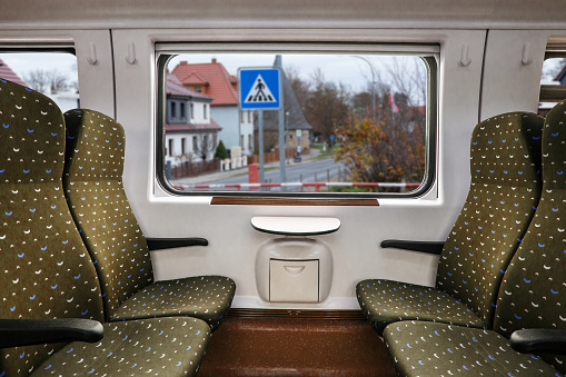 Empty interior of the train for long and short distance in Europe train carriage with blue seats.