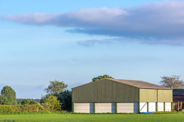 Prefabricated Barn Prefabricated farm building in a rural setting on a sunny day with blue sky. east riding of yorkshire photos stock pictures, royalty-free photos & images