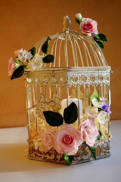 Bird cage with spring blossom flowers. Wedding decorations.