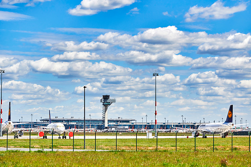 Berlin-Schoenefeld, Germany - May 20, 2020: Airplanes parked at Berlin-Schoenefeld Airport that are not needed due to the corona pandemic.