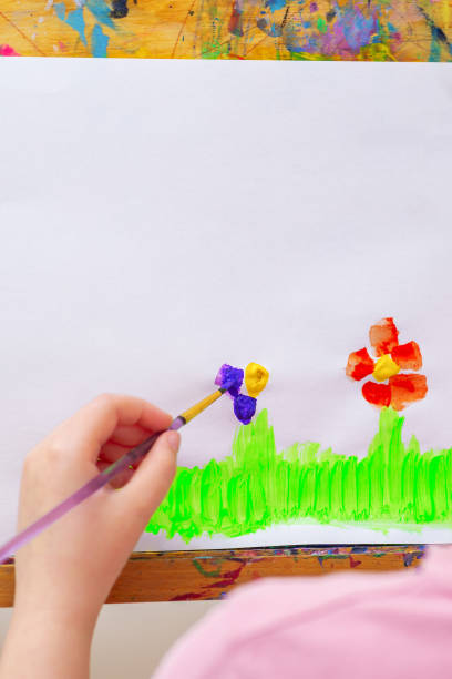 istock Child is drawing flowers 1226580846