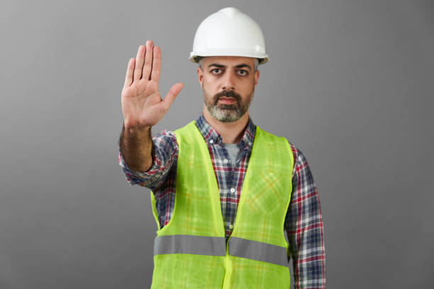 istock Worker man with medical mask showing stop gesture 1226580951
