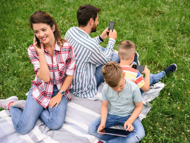 istock Family using mobile phones together in nature. 1226581317