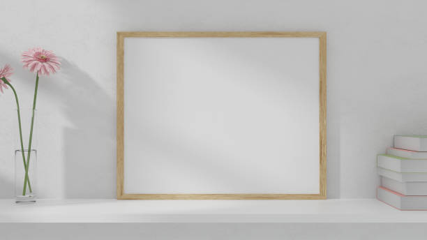 istock A blank picture and poster frame set on a shelf on the wall. 1226582151