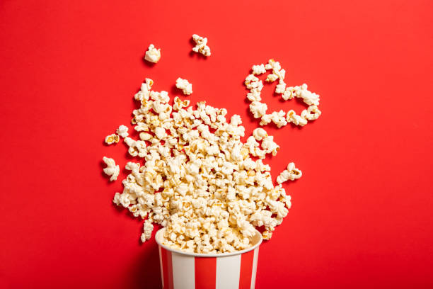 istock Paper cup with popcorn on a red background 1226582495
