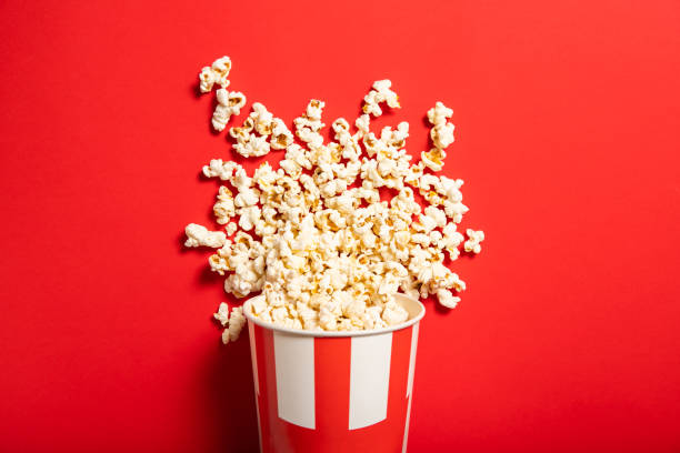 istock Paper cup with popcorn on a red background 1226582496