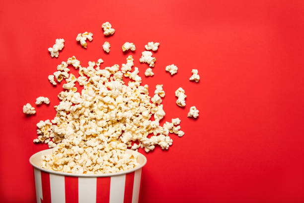 istock Paper cup with popcorn on a red background 1226582659