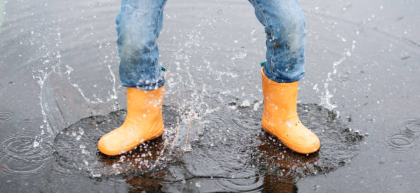 istock Feet of a child playing in a puddle 1226585508