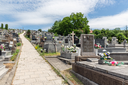 Szomolya , Hungary - July 07, 2019: Graveyard with footpath upon a hill in Szomolya near Eger, Hungary