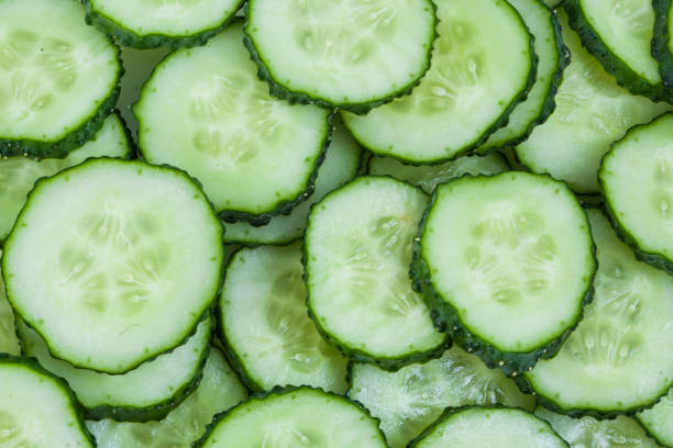 istock Fresh green slices cucumbers background 1226586764
