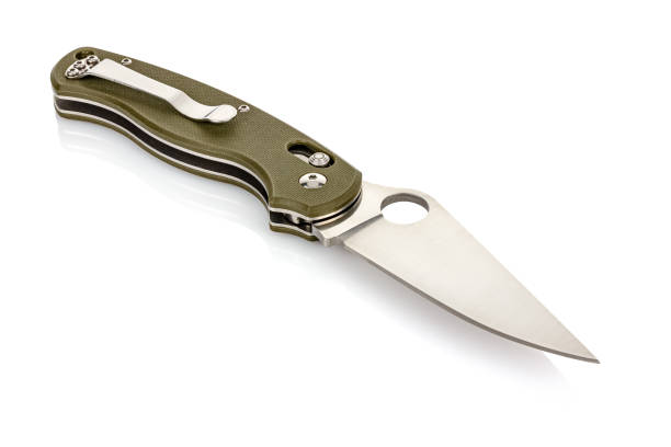 istock Lying open folding pocket knife with matte blade and dark green composite plastic cover plates on steel handle isolated on white background with reflection on glossy surface. Pocket knife close-up 1226586820