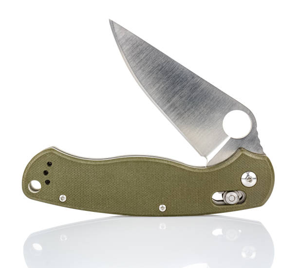 istock Open folding pocket knife with matte blade and textured dark green composite plastic cover plates on steel handle isolated on white background with reflection on glossy surface. Pocket knife close-up 1226586842