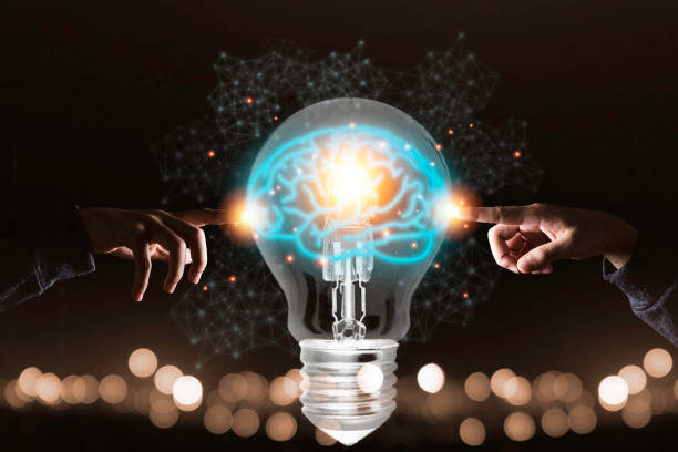 istock Two hands touching the virtual light bulb with brain. Creative new business idea concept. 1226587694