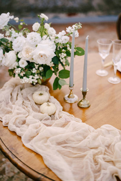 istock Closeup of a wooden table decorated for a wedding dinner. 1226587937