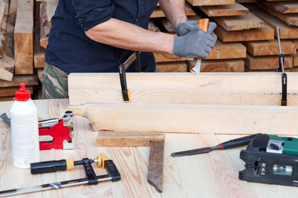 istock Carpenter's hands that work with cutter. Man working with plane on wooden background. Joiner work in carpentry. 1226588505
