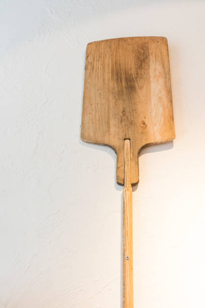 istock wooden spatula for bread or pizza, hanging on white kitchen wall 1226589757