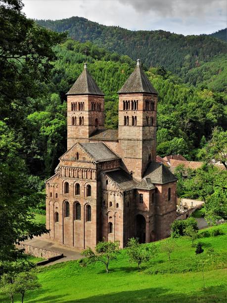murbach abbey in the alsace is located beautifully surrounded by green hills of the vosges - murbach imagens e fotografias de stock