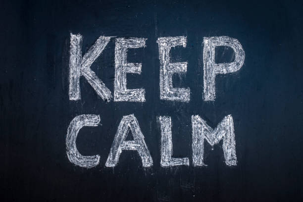 Keep calm written in chalk on a black board.