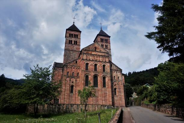 footpath leading to the entrance of murbach abbey in the vosges - murbach imagens e fotografias de stock