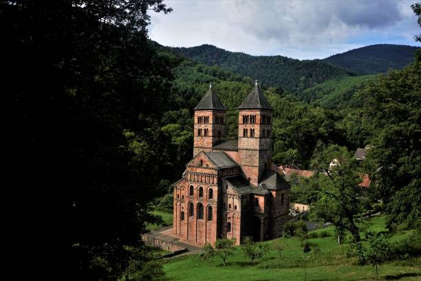 view on murbach abbey with green hills surrounding the building - murbach imagens e fotografias de stock