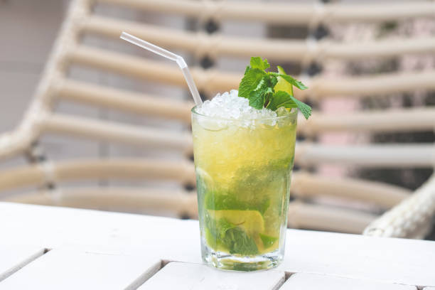 istock Classical mojito with lemon, soda, mint in glass on wooden background 1226592196