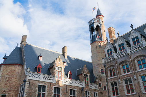 Brugge/Belgium-Oct 28 2019:Bellfry and City Hall at Market Square in Bruges, the capital of West Flanders in northwest Belgium, Traditional Colorful Brick Buildings in Market Square