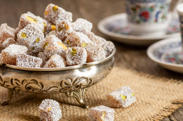 turkish delight in hollowware and turkish coffee, traditional turkish sweet double roasted with pistachio nuts and coconut - turkish delight imagens e fotografias de stock