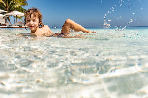 istock LIttle boy lying in the sea 1226608546