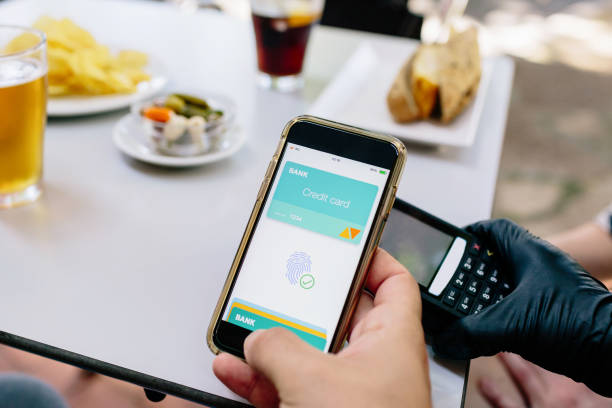 istock Contactless payment from a smartphone to a POS terminal in a restaurant. 1226609985