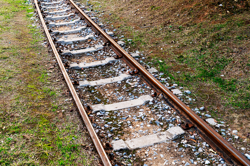 Close up of railroad tracks, points and sleepers filled with gravel in England.