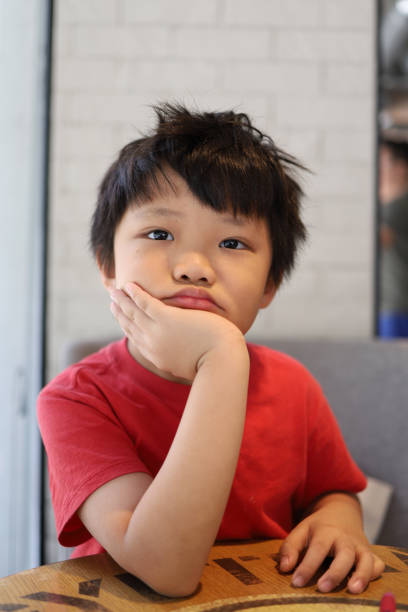 istock Boring boy resting on the desk 1226613529